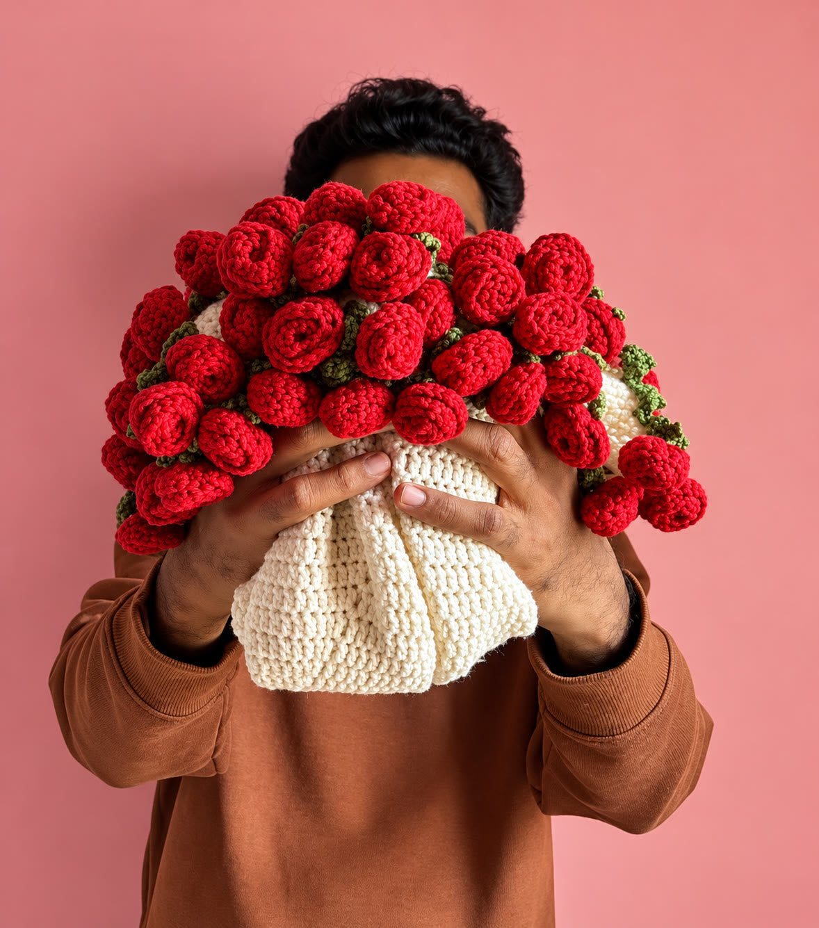 Red rose bouquet blanket held against a pink background